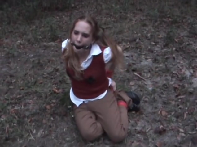 Coed hogtied and ballgagged in woods
