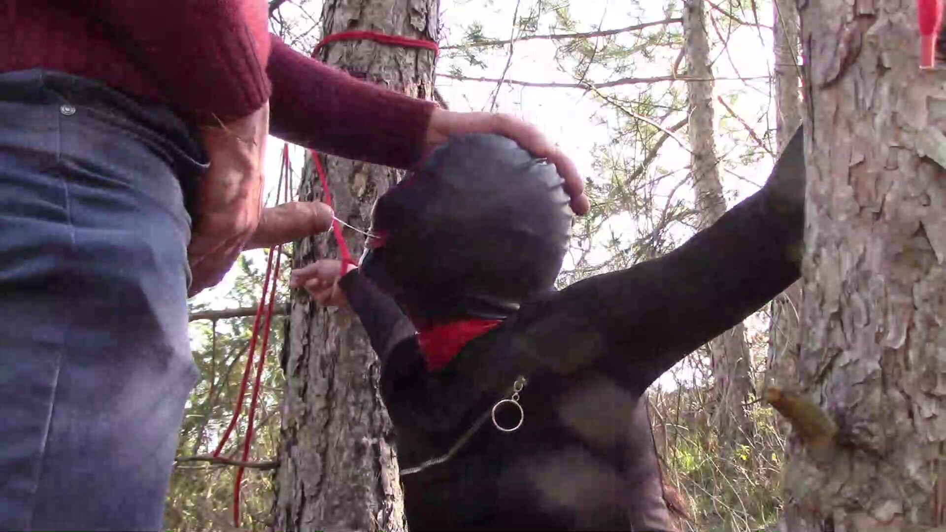 Tied to a tree on a sexy outfit, masked and outdoor deepthroat with no mercy
