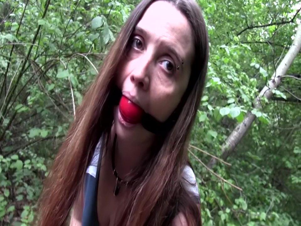 Walking cuffed and gagged outdoors
